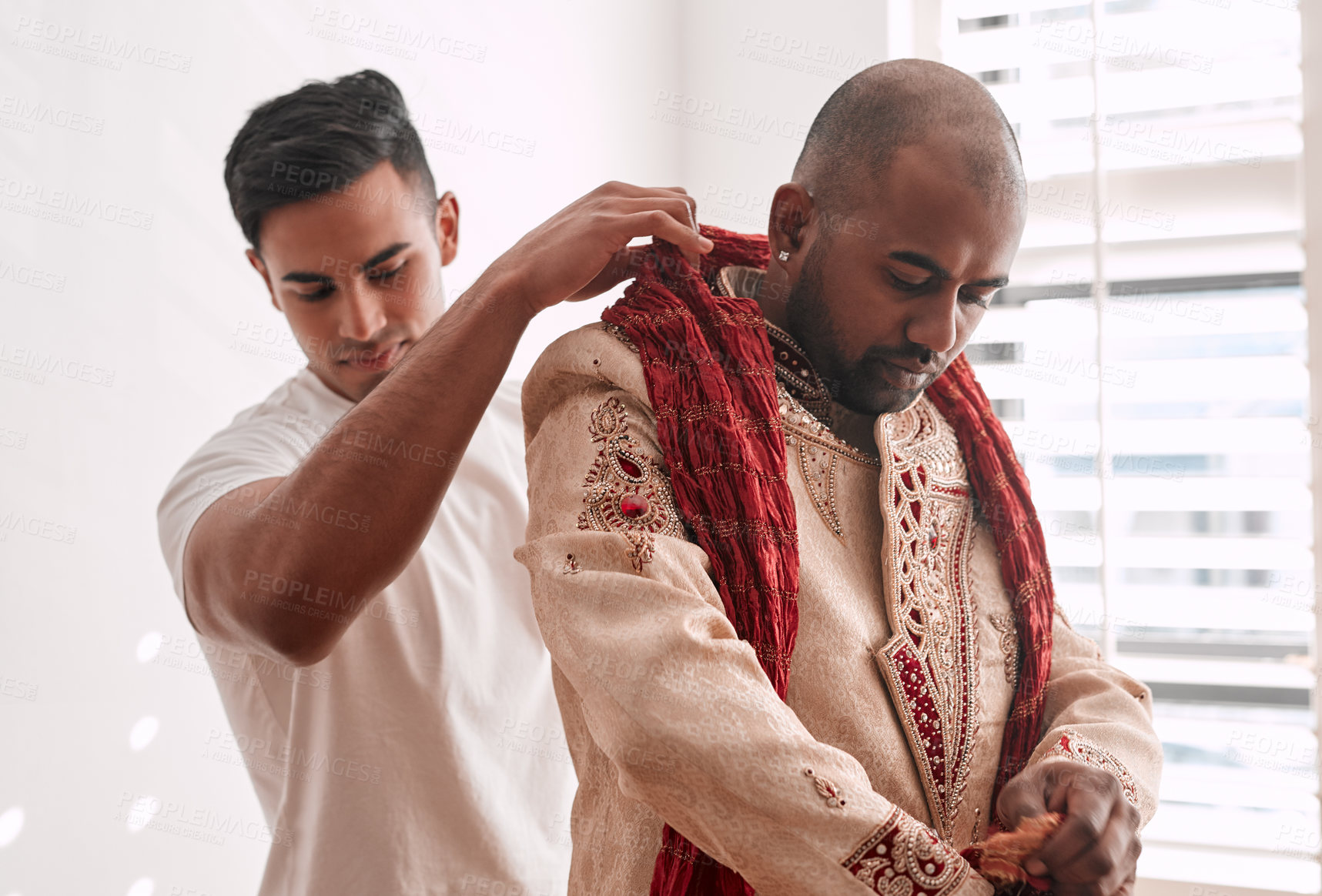 Buy stock photo Cropped shot of a young best man helping the groom with getting dressed on the wedding day