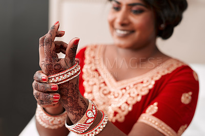 Buy stock photo Cropped shot of a beautiful young bride putting on her bracelets in preparation for her wedding