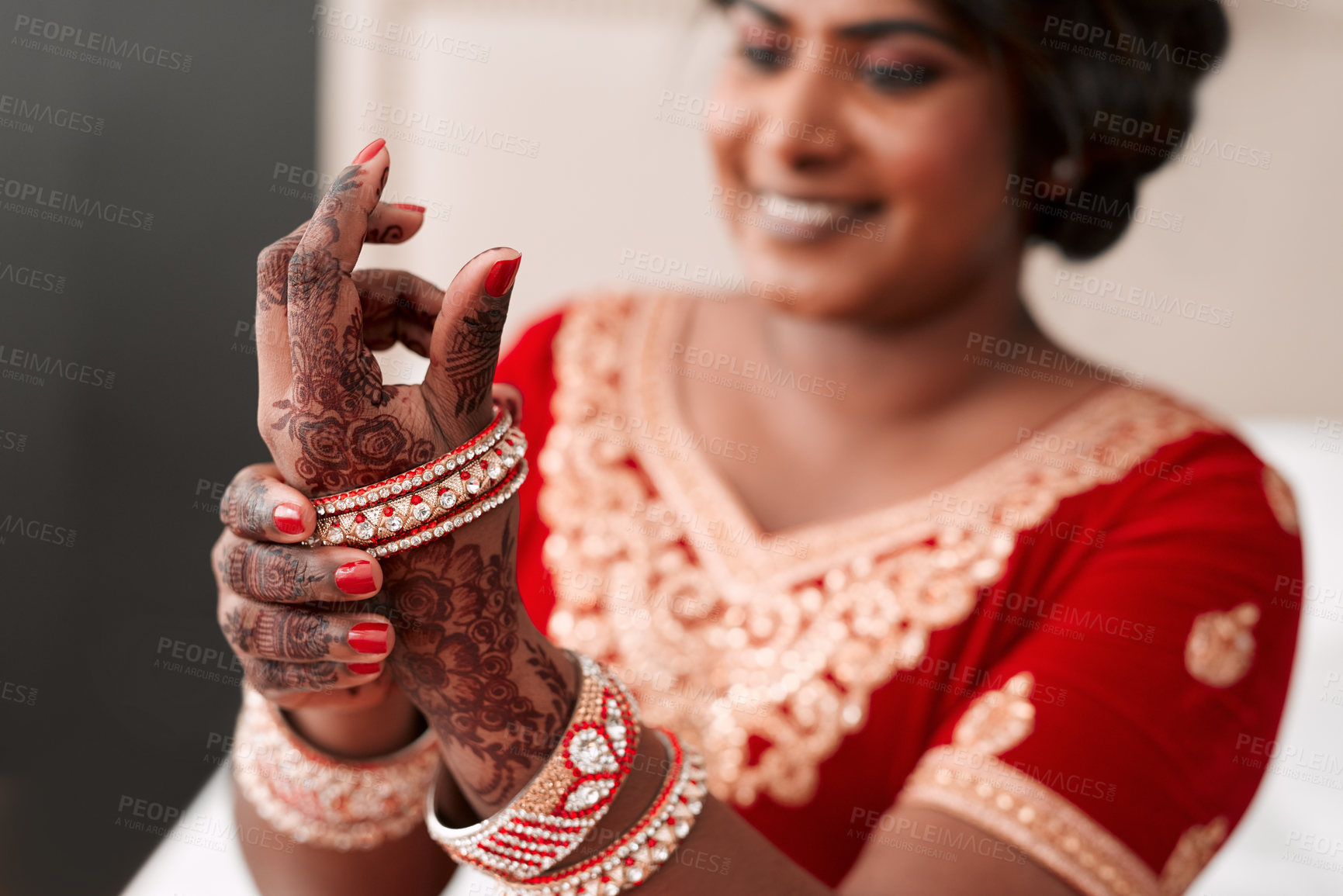 Buy stock photo Indian, bride and hands with henna, bracelet and morning of wedding, luxury and culture for woman. Celebration, jewellery and person in bedroom with clothes, ready and traditional for event in Dubai