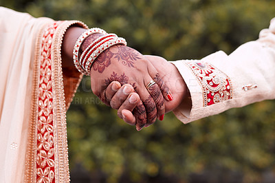 Buy stock photo Cropped shot of an unrecognizable newlywed couple holding hands together on their wedding day