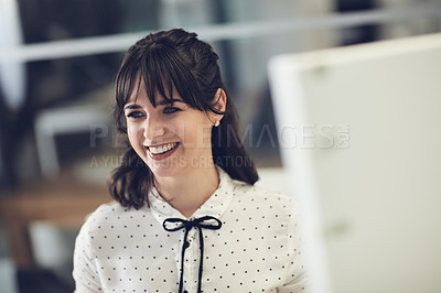 Buy stock photo Shot of an attractive young businesswoman using a computer in a modern office