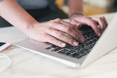 Buy stock photo Cropped shot of a businesswoman using a laptop at her desk in a modern office