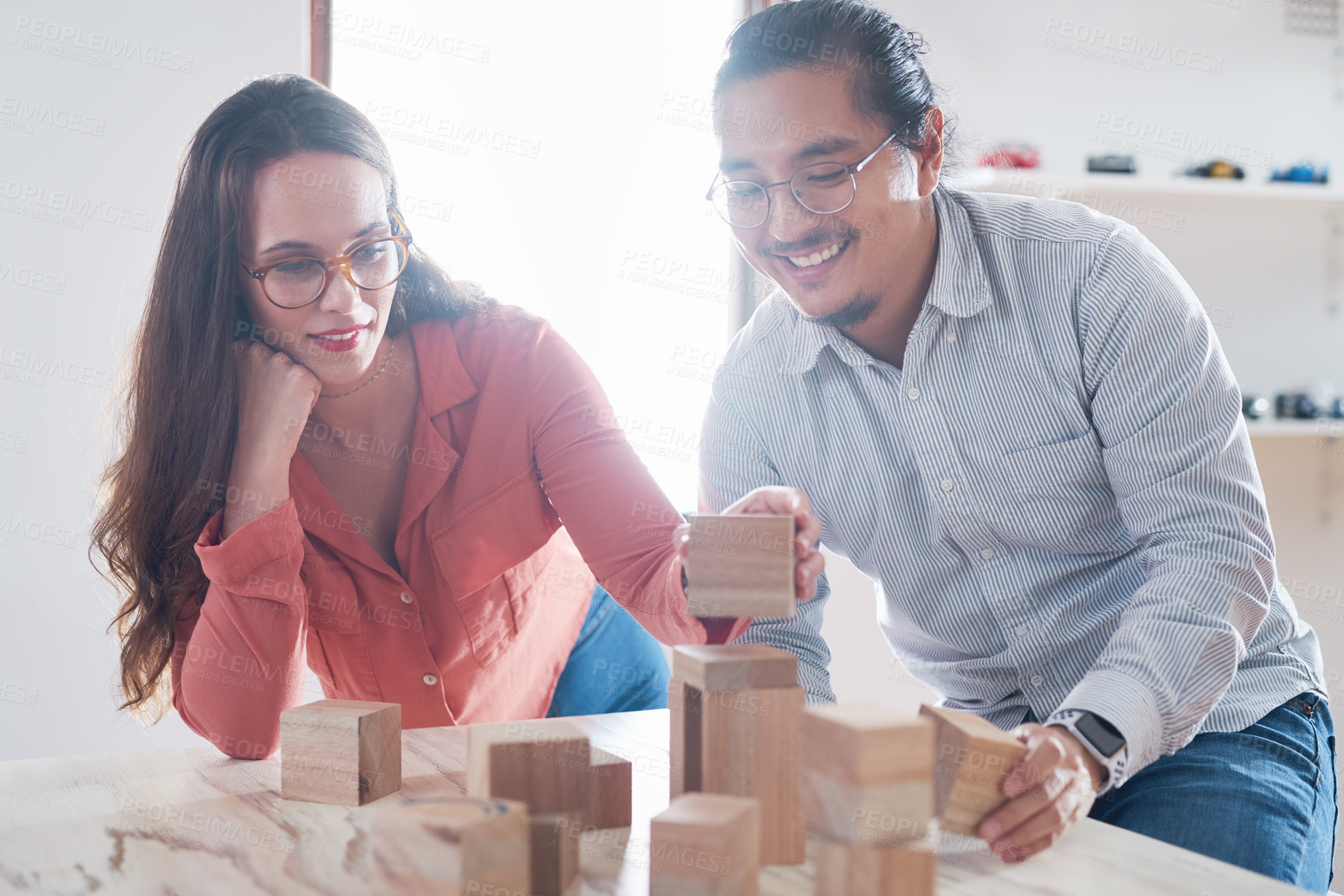 Buy stock photo Teamwork, man and woman with building blocks in startup office for challenge game and design innovation with vision. Engineering, architecture and designer team with block games for problem solving