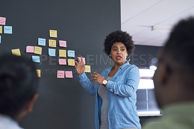 Buy stock photo Shot of a team of young businesspeople having a brainstorming session in a modern office