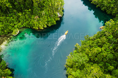 Buy stock photo Island, ocean and drone view of a boat in nature with trees for sailing on vacation or weekend trip. Travel, adventure and aerial view of speedboat on sea of tropical resort water for summer holiday.