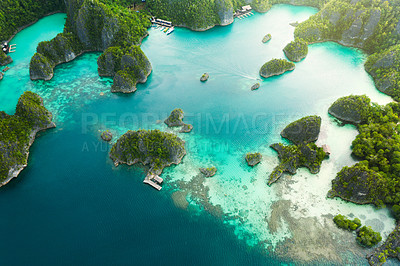 Buy stock photo Travel, aerial and ocean on island for holiday, adventure and vacation on Raja Ampat in Indonesia. Nature, seascape and drone view of tropical water for landscape, environment or traveling on islands