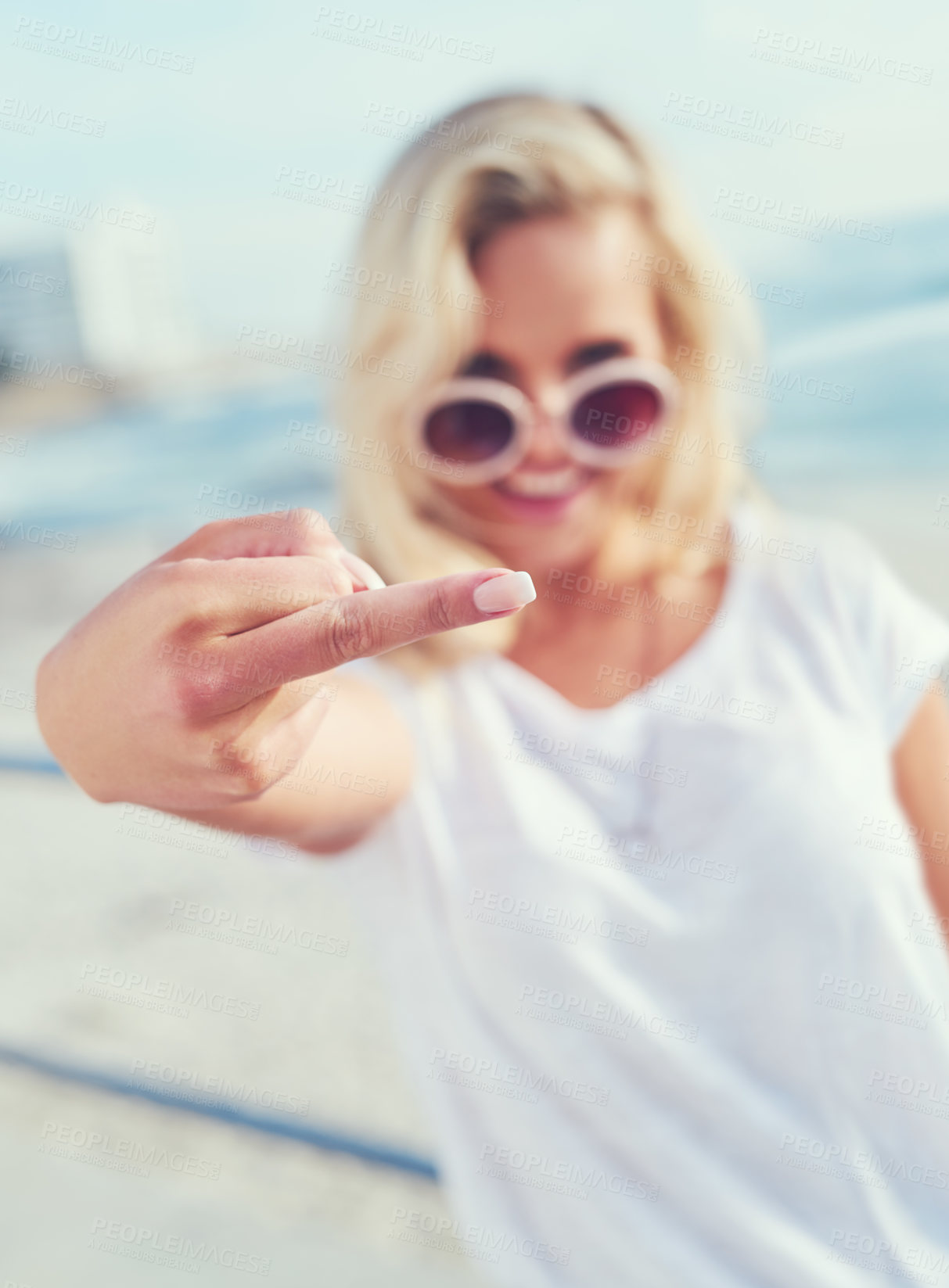 Buy stock photo Beach, sunglasses and hand of woman with middle finger for rebel, carefree or freedom on vacation. Travel, seaside and female person by ocean with vulgar, rude or punk gesture on coastal holiday.