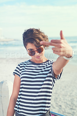 Buy stock photo Cropped shot of a young woman showing middle finger