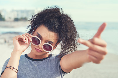 Buy stock photo Beach, vacation and portrait of woman with middle finger for rebel, carefree or freedom on holiday. Travel, sunglasses and female person by ocean with vulgar, rude or punk gesture on coastal trip.