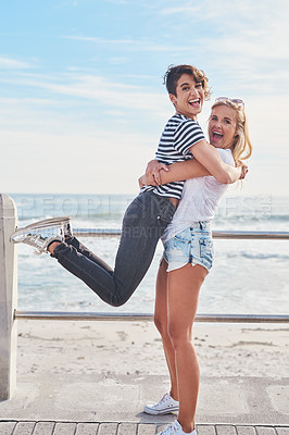 Buy stock photo Shot of two friends spending the day together on a sunny day