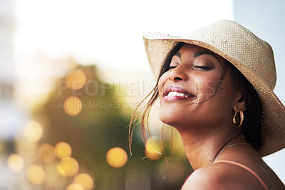 Buy stock photo Cropped shot of an attractive young woman feeling cheerful while out and about in the city