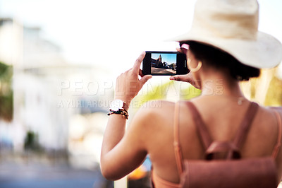 Buy stock photo Rearview shot of an unrecognizable young woman taking photos in a foreign city