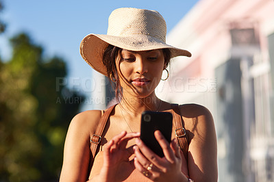 Buy stock photo Shot of an attractive young woman using her cellphone while out in the city