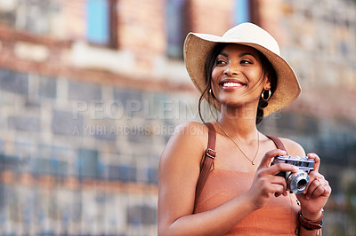 Buy stock photo Shot of an attractive young woman taking pictures with a camera while exploring in a  foreign city