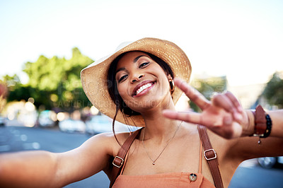 Buy stock photo Portrait of an attractive young woman taking selfies while out in the city