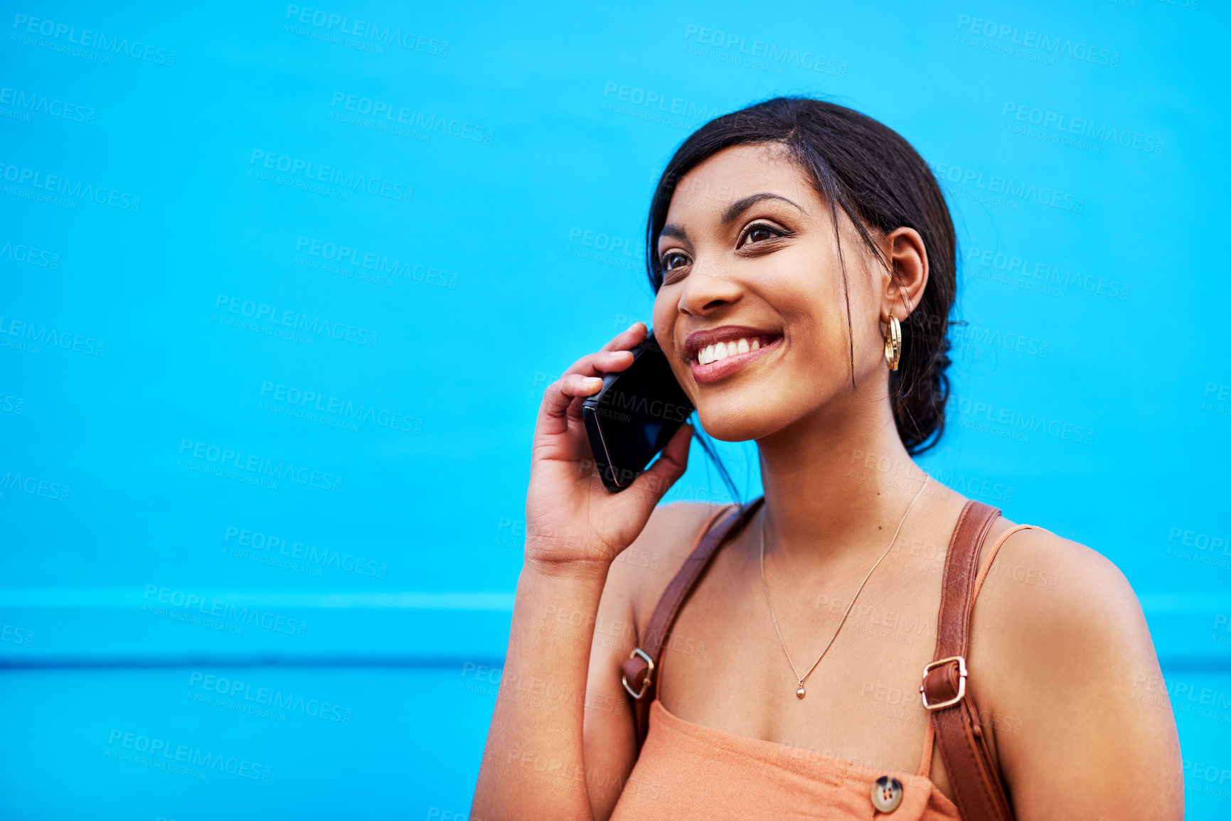 Buy stock photo Girl, talking and happy with phone call outdoor for communication, conversation and backpack. Woman, student and mockup on smartphone with consulting for university application on blue background