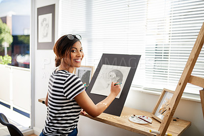 Buy stock photo Portrait of an attractive young artist drawing a portrait of a woman inside her studio