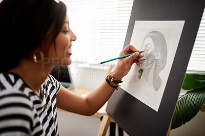 Buy stock photo Shot of an attractive young artist drawing a portrait of a woman inside her studio