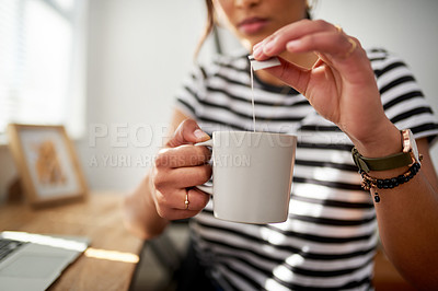Buy stock photo Cropped shot of an unrecognizable woman enjoying a cup of tea while woking inside her studio