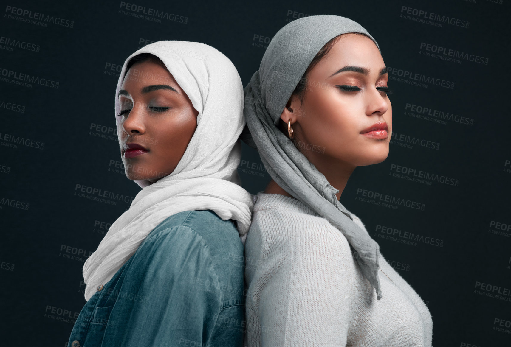 Buy stock photo Fashion, muslim women and together in studio for culture, sisterhood or support on black background. Eyes closed, skincare or islamic people with cosmetics for diversity, hijab or attire for religion