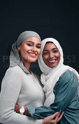 Buy stock photo Muslim women, fashion and smile in studio for culture, sisterhood and portrait on black background. Hug, friends and islamic people with makeup for diversity, hijab or cosmetics for religion