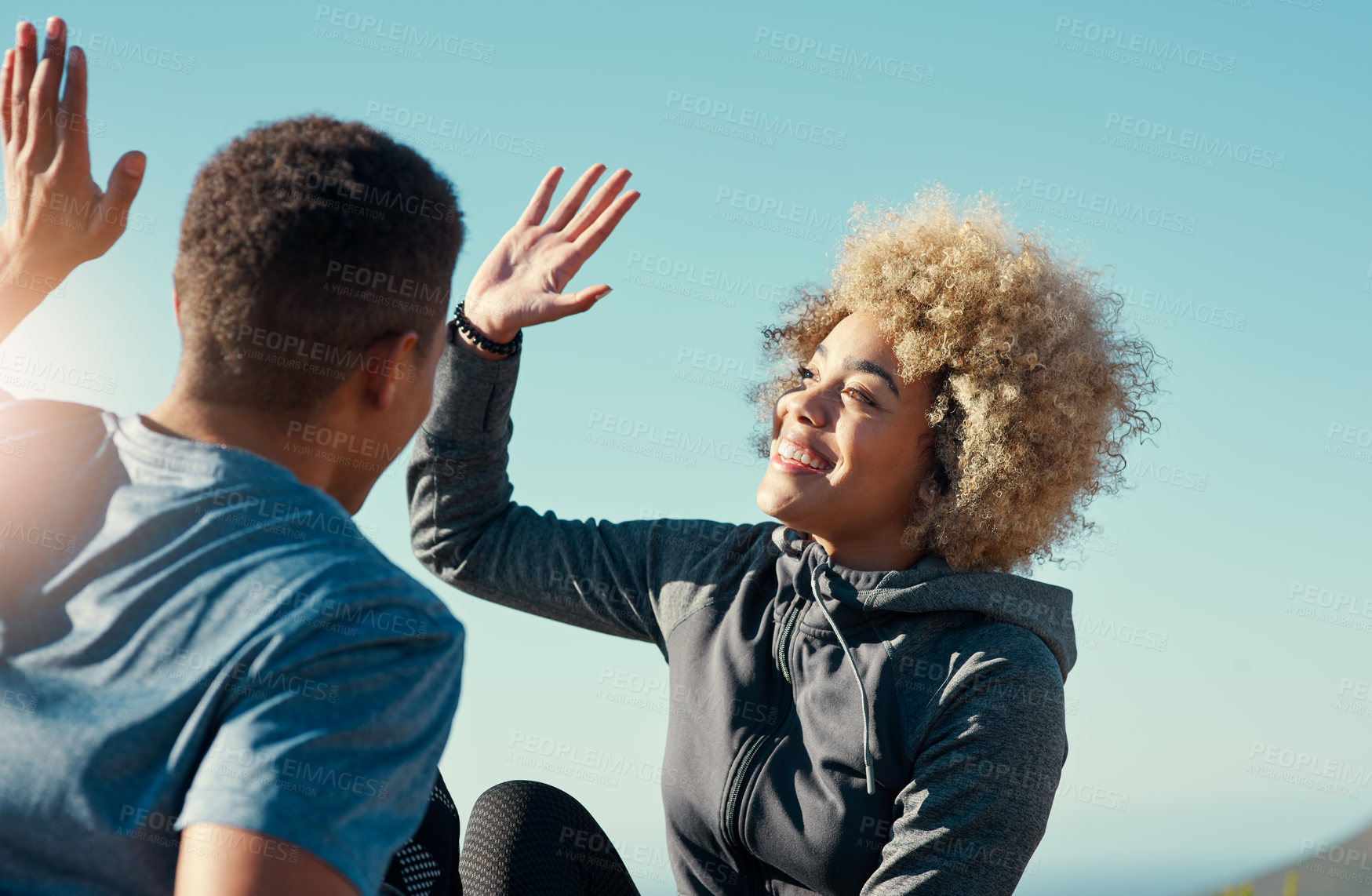 Buy stock photo Cropped shot of a young couple giving each other other five while out for a run