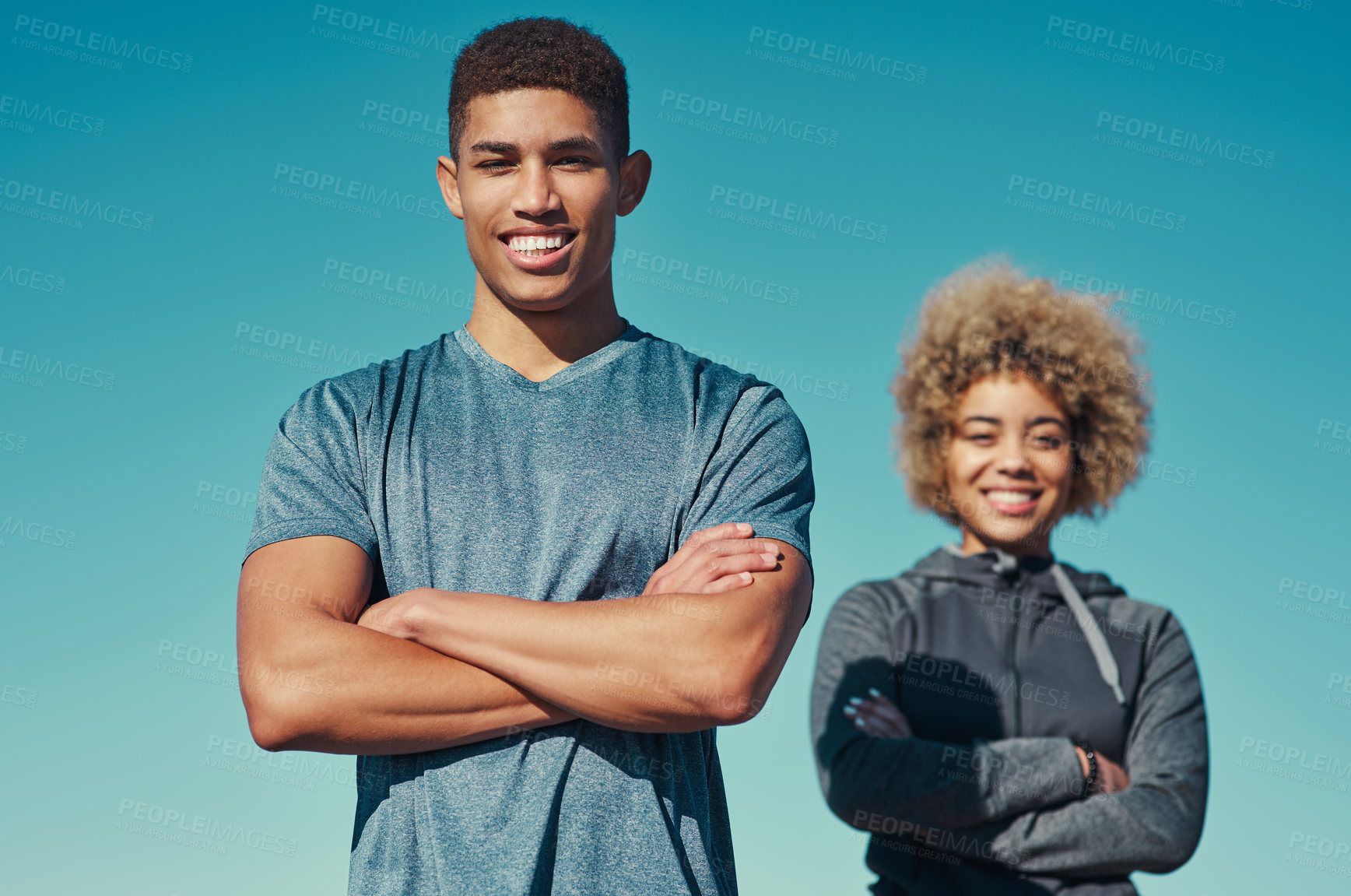 Buy stock photo Arms crossed, fitness and portrait of happy man or couple outdoor for exercise, training or pride with coach. Face, workout and African team with woman for wellness, confident or body health by sky