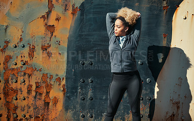 Buy stock photo Shot of a young woman warming up before her workout outdoors