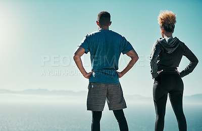 Buy stock photo Rearview shot of a young couple looking at the view while out exercising