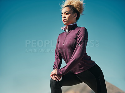 Buy stock photo Cropped shot of a young woman stretching outdoors before her run