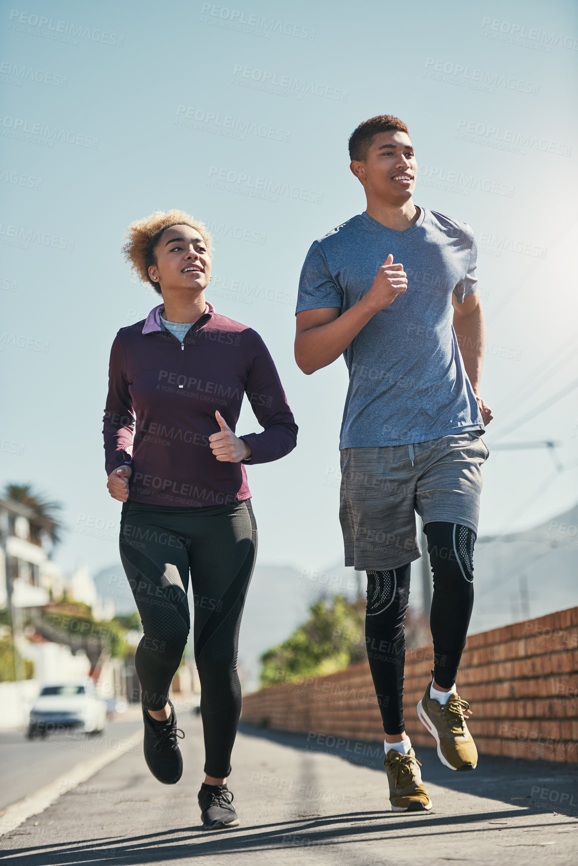 Buy stock photo Shot of a young couple out for a run together