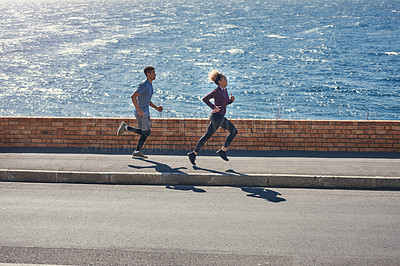 Buy stock photo Shot of a young couple out for a run together