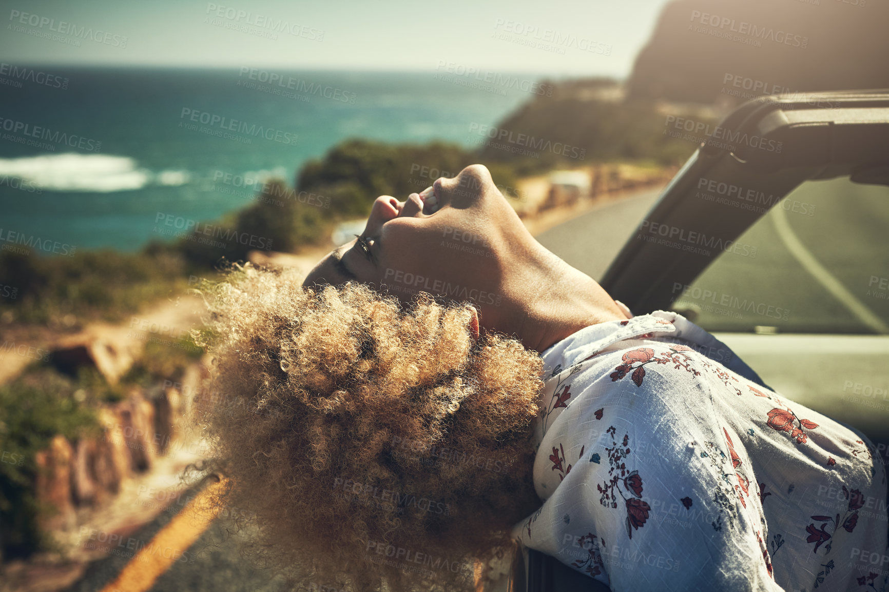 Buy stock photo Cropped hot of a young woman enjoying herself on a road trip