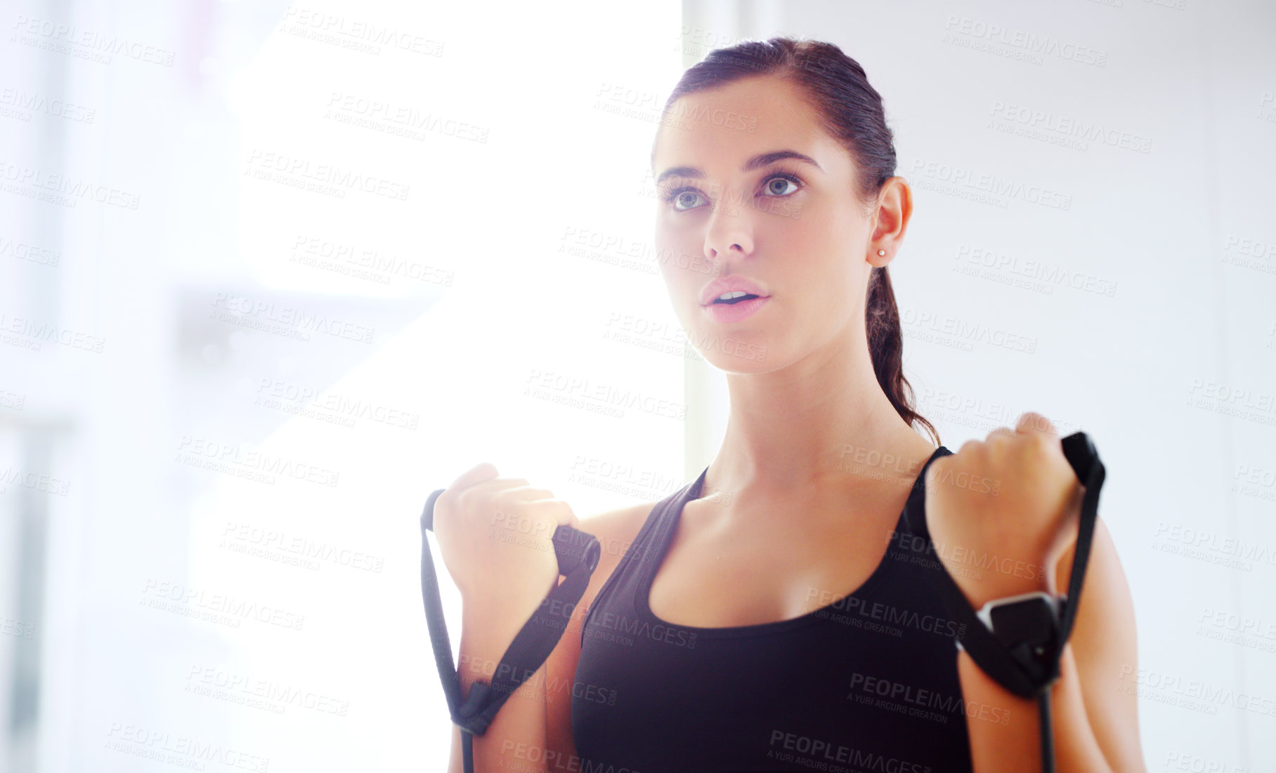 Buy stock photo Shot of an attractive young woman working out at the gym