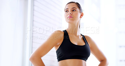 Buy stock photo Shot of an attractive young sportswoman posing with her hands on her hips at the gym