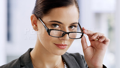 Buy stock photo Portrait of an attractive young businesswoman wearing spectacles while working in her office