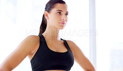 Buy stock photo Shot of an attractive young sportswoman posing with her hands on her hips at the gym