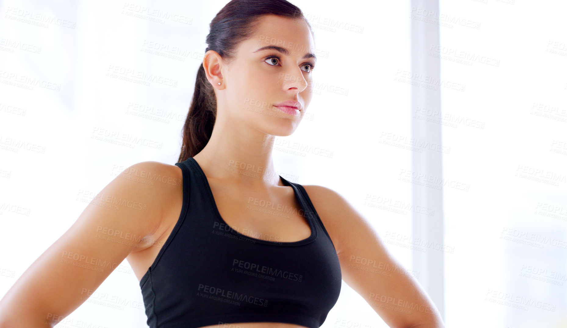 Buy stock photo Shot of an attractive young sportswoman posing with her hands on her hips at the gym