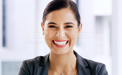 Buy stock photo Portrait of an attractive young businesswoman smiling and feeling cheerful in her office