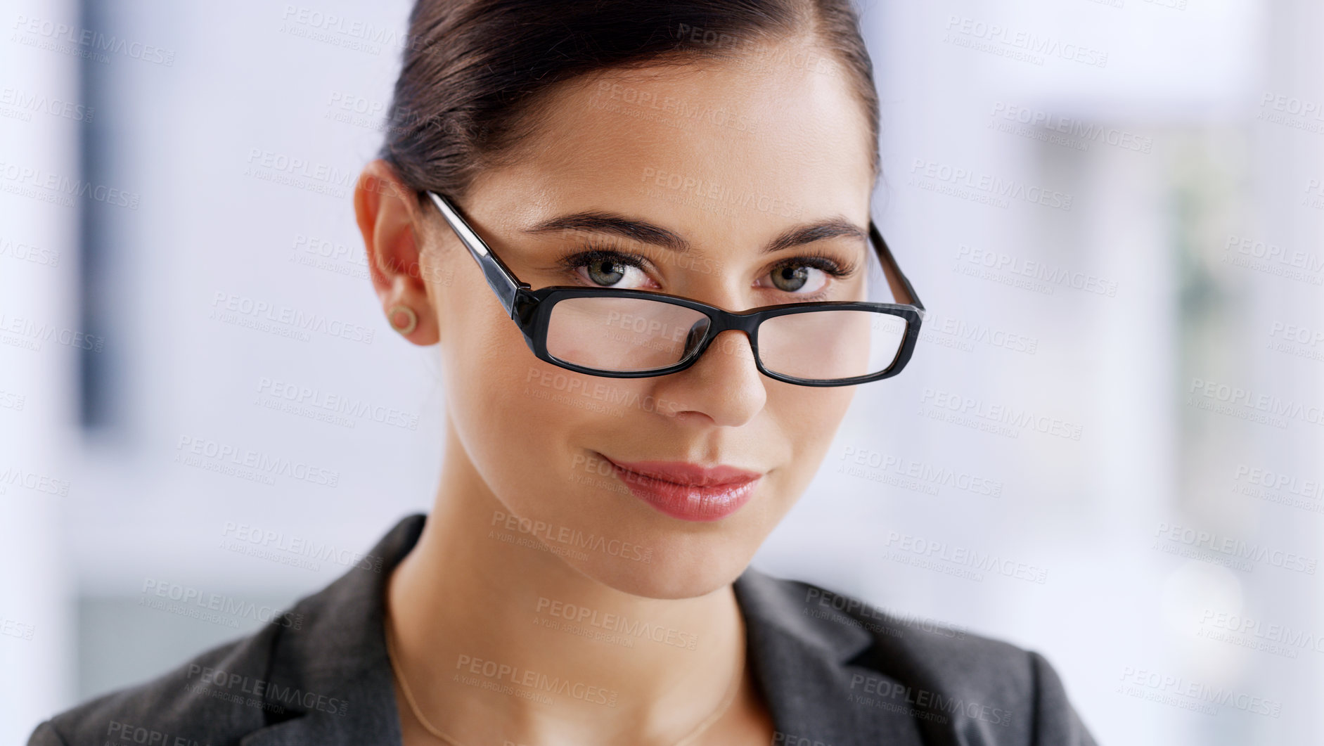 Buy stock photo Portrait of an attractive young businesswoman wearing spectacles while working in her office