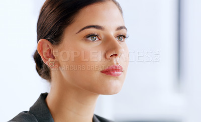 Buy stock photo Shot of an attractive young businesswoman looking thoughtful while working in her office