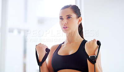 Buy stock photo Shot of an attractive young woman working out at the gym