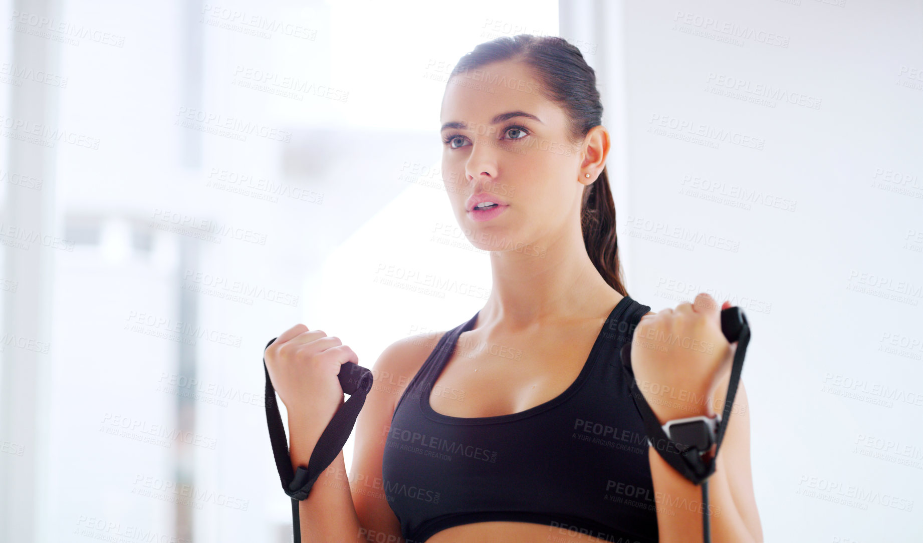Buy stock photo Shot of an attractive young woman working out at the gym