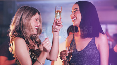 Buy stock photo Shot of two young women dancing in a nightclub