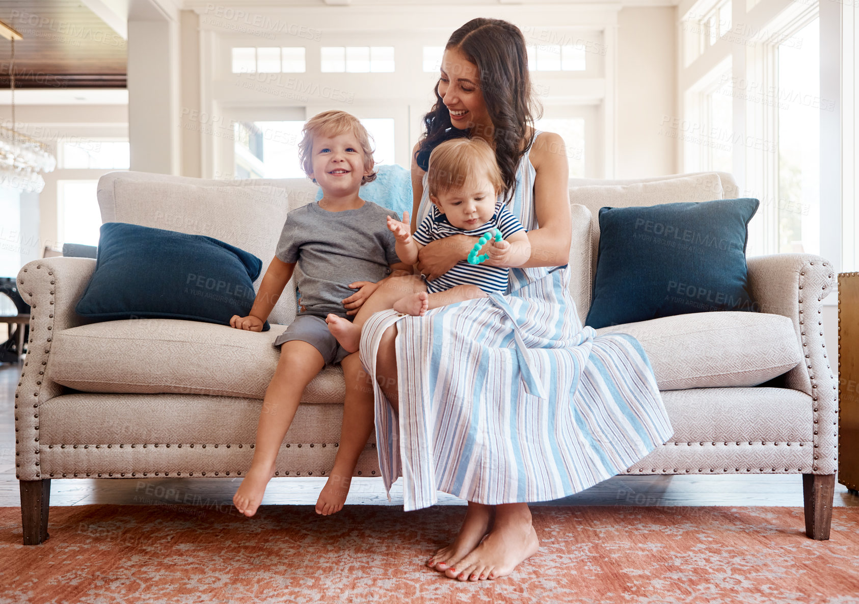 Buy stock photo Shot of a mother bonding with her two little sons at home