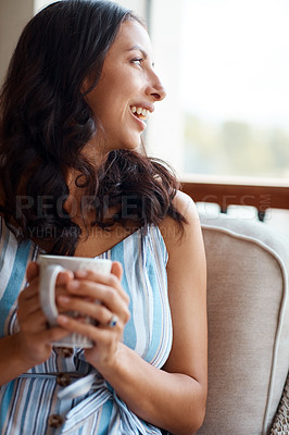 Buy stock photo Shot of a young woman drinking coffee while relaxing on the porch at home