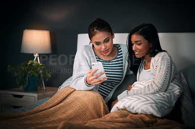 Buy stock photo Social media, women and cellphone in bed for relax, networking and meme or reel on weekend. Technology, emoji and friends in home for streaming, update and online for dating app and conversation 