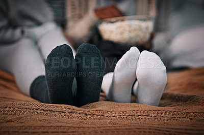 Buy stock photo Cropped shot of two young women wearing socks while lying on a bed together