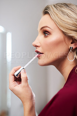 Buy stock photo Cropped shot of a beautiful young bride applying lipstick while preparing for her wedding in her dressing room