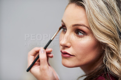 Buy stock photo Cropped shot of a beautiful young bride applying make-up while preparing for her wedding in her dressing room